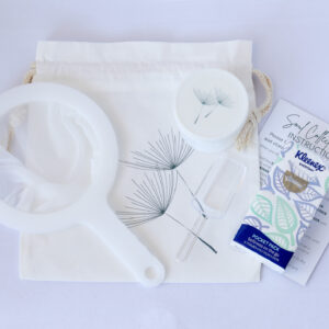 White strainer, opaque jar, scoop, carry bag, instruction card and packet of facial tissues.